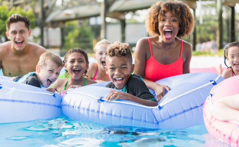 Families in pool with floats